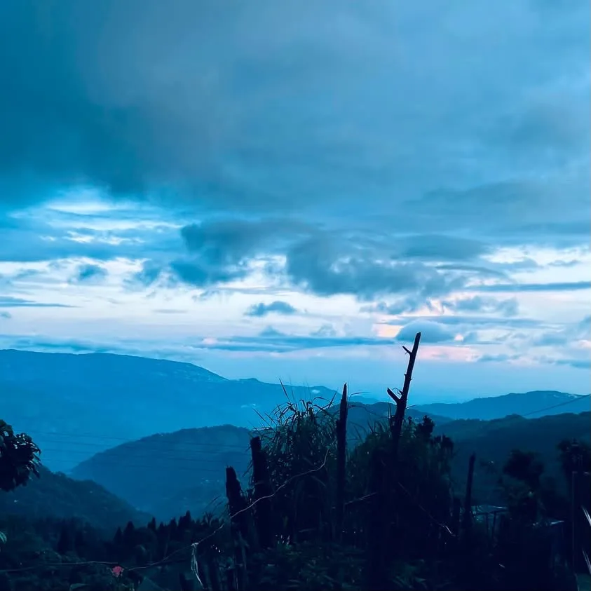 Serene blue hour mountain silhouettes surrounding Sukhia Pokhari Darjeeling