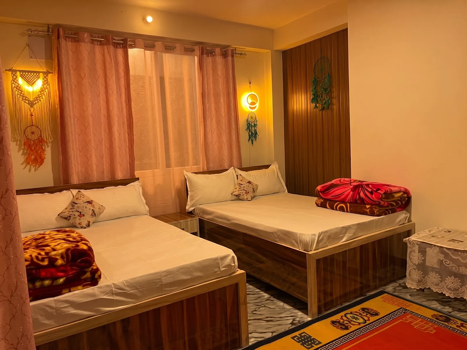 Family Quad Suite twin double beds with pink curtains and macramé wall decor at Zambala Dwelling Nest